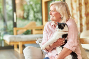 senior woman holding a cat smiling