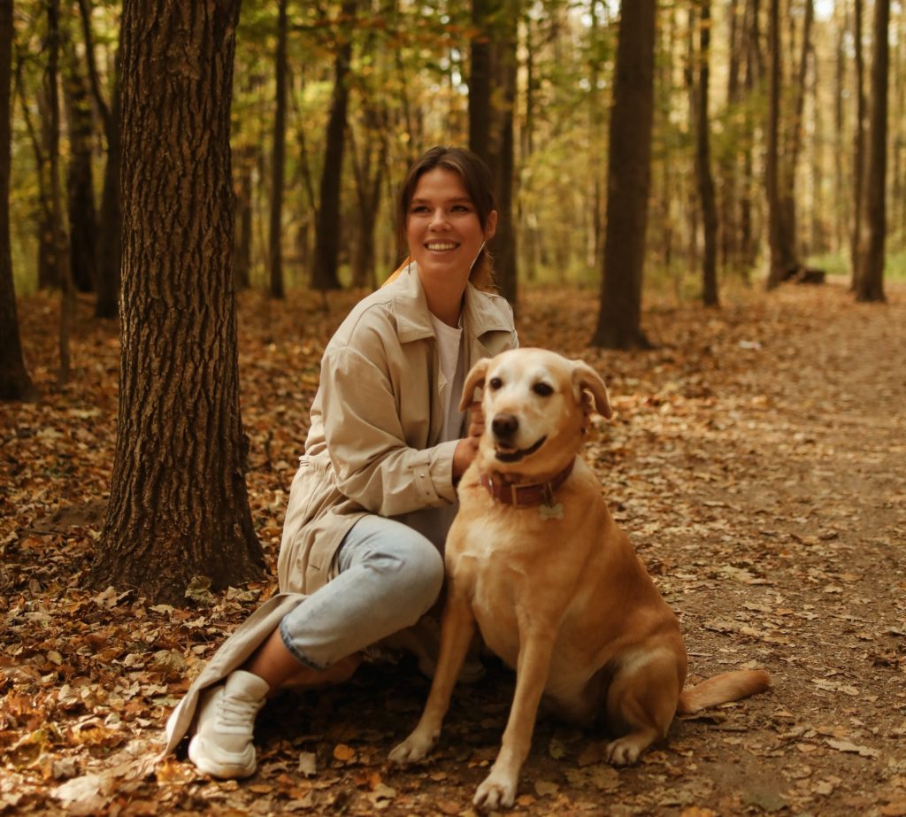 Dog and owner on a hike in the woods