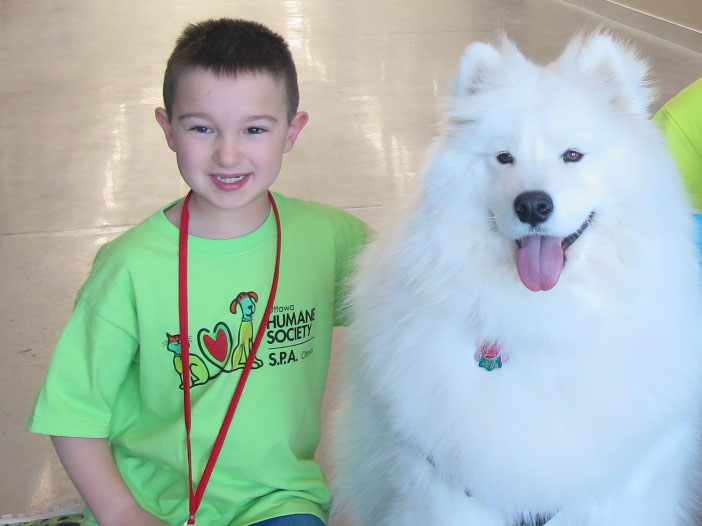 camp kid with big fluffy white dog