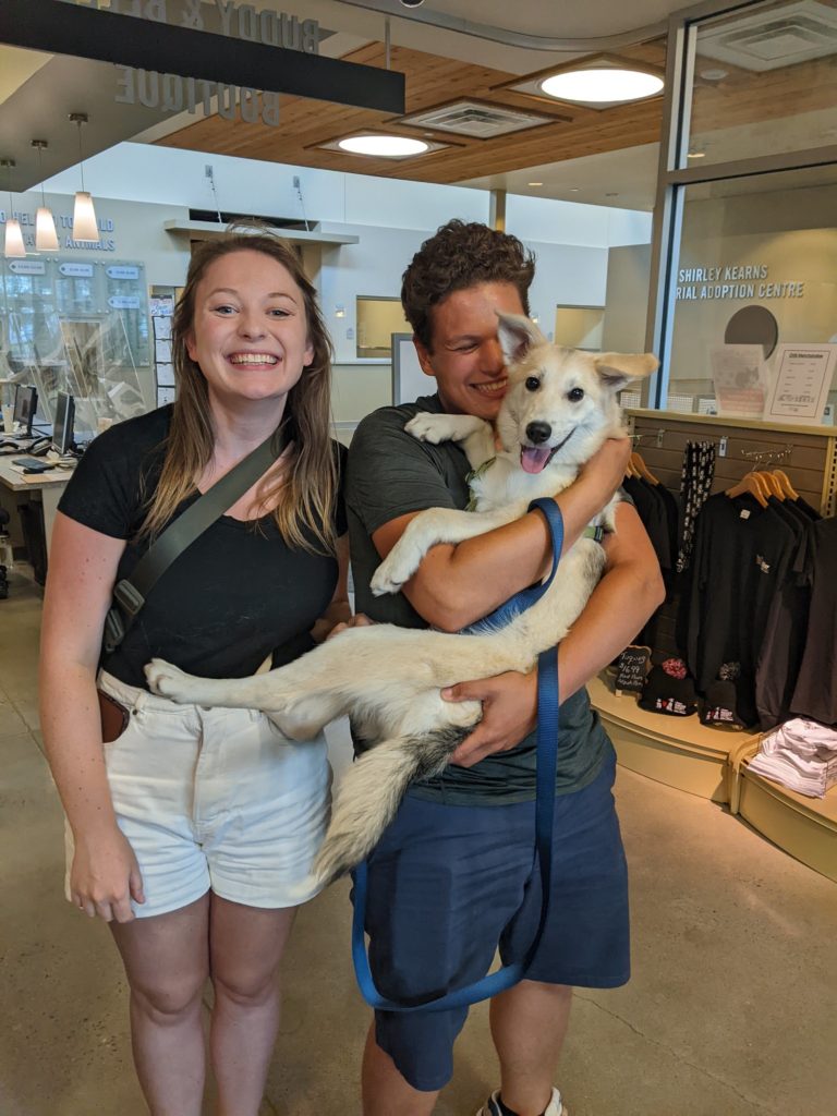 Couple holding adopted dog